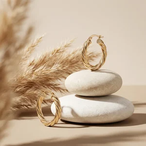 Minimalist gold hoops on river stones