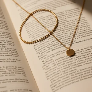 Delicate gold necklace on paper