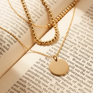 Gold necklace on open book