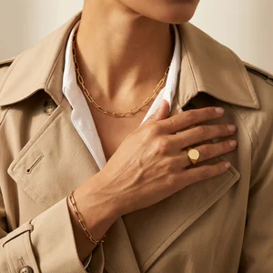 Gold jewelry on beige trench coat
