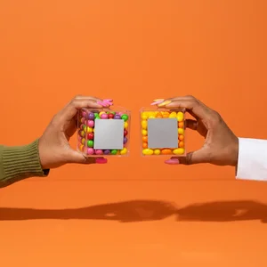 Colorful candy boxes held by hands