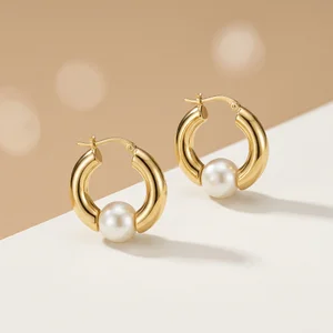 Elegant pearl hoop earrings on beige