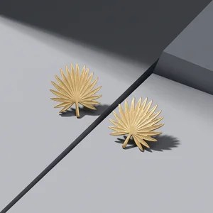 Gold leaf earrings on gray