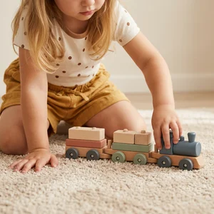 Toddler playing with wooden train