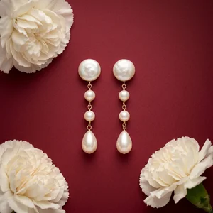 Pearl drop earrings on red