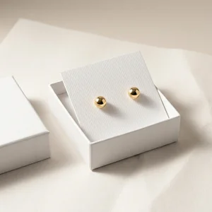 Minimalist gold studs in white box