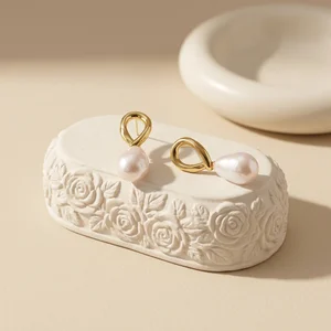 Elegant pearl earrings on textured stone