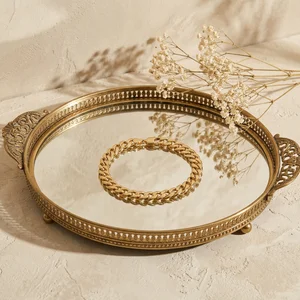 Vintage gold jewelry on mirror tray