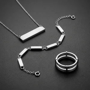 Modern silver jewelry on dark gray