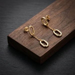 Elegant gold earrings on wood