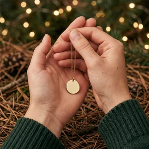 Festive gold pendant in hands
