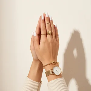 Gold jewelry and watch on hand