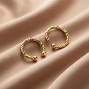 Elegant gold earrings on satin