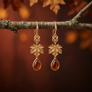 Golden maple earrings on branch