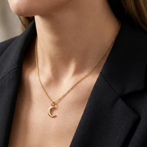 Gold moon necklace on model