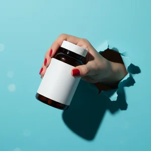 Vitamin bottle through paper