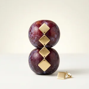 Geometric gold earrings on plums