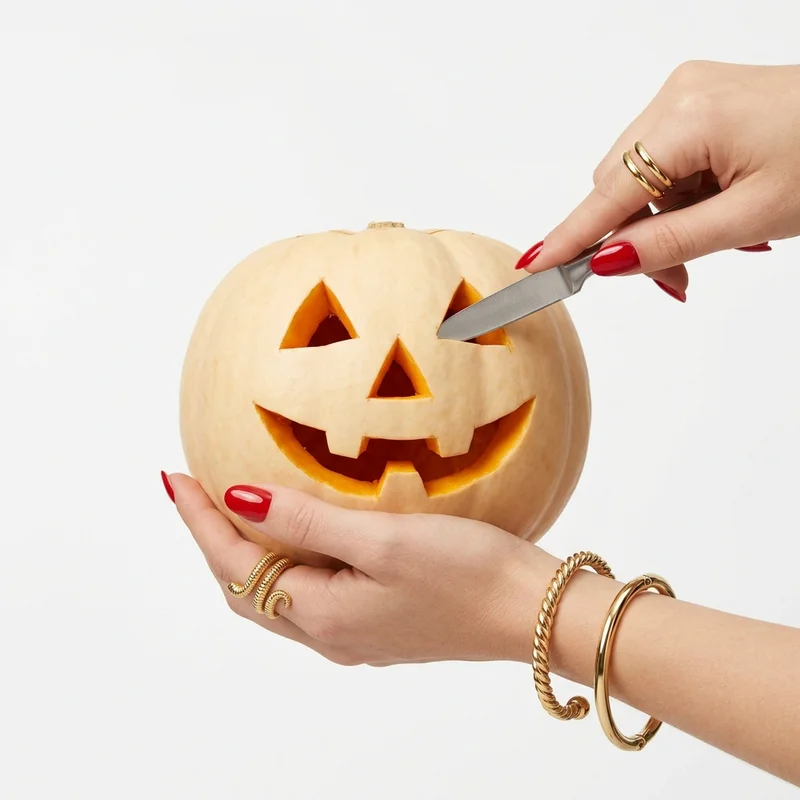 Elegant Halloween pumpkin carving editorial