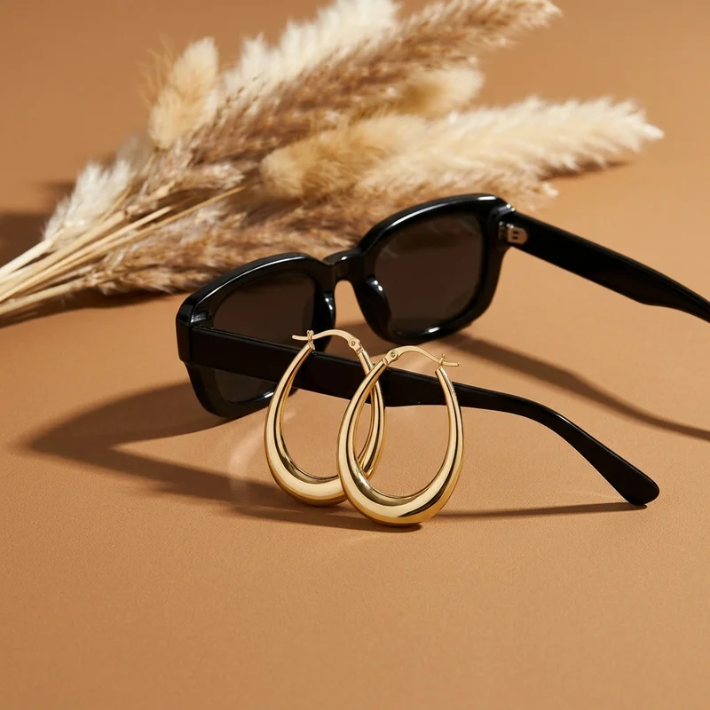 Chic sunglasses and gold earrings