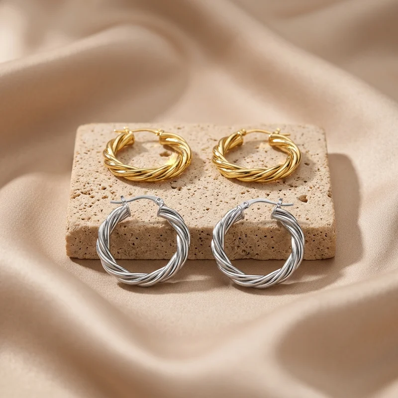 Twisted hoop earrings on stone