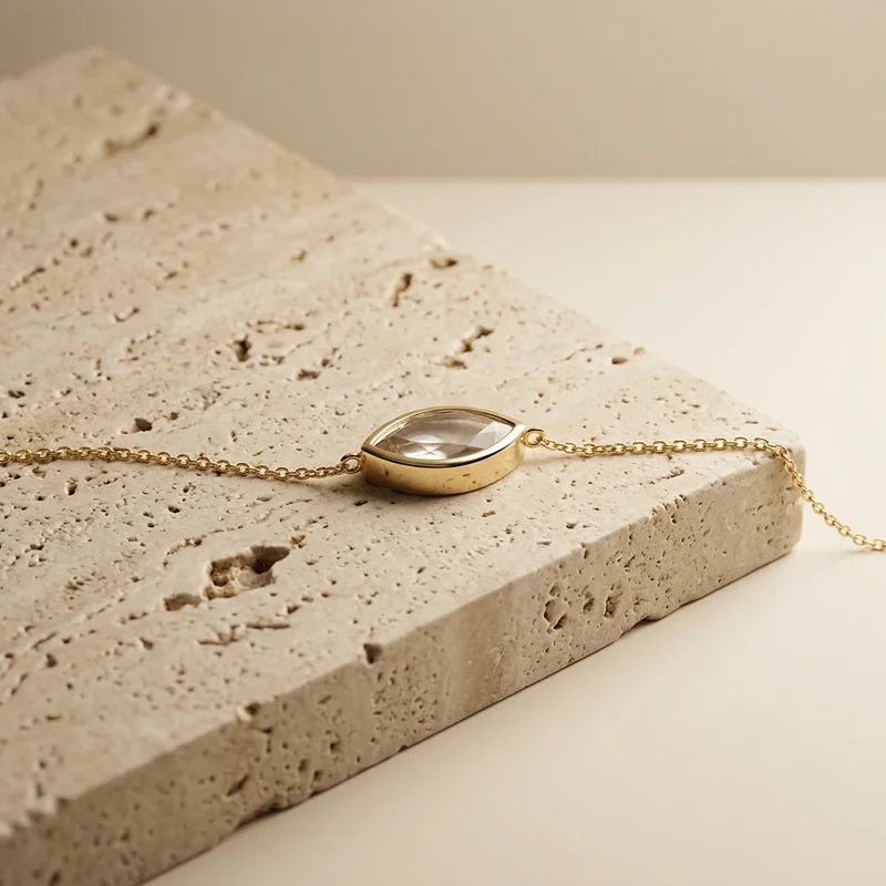 Minimalist gold necklace on stone