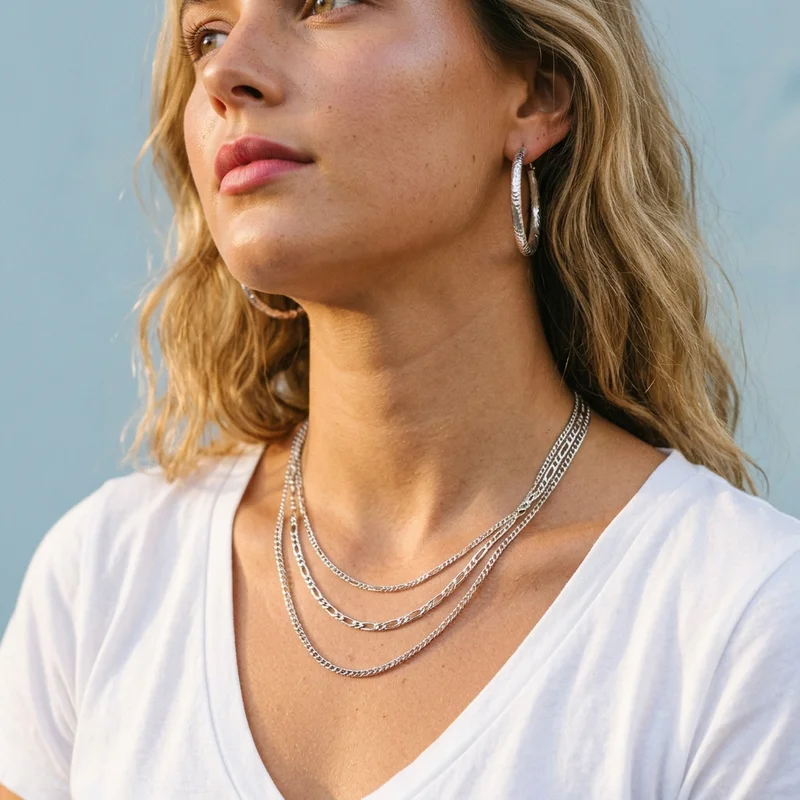 Stacked silver chains on model