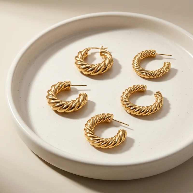 Luxury gold earrings on ceramic