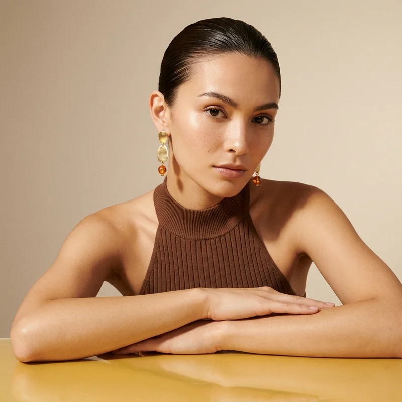 Modern leaf earrings on model