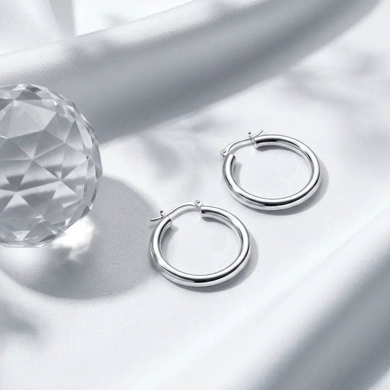 Elegant silver hoops on satin