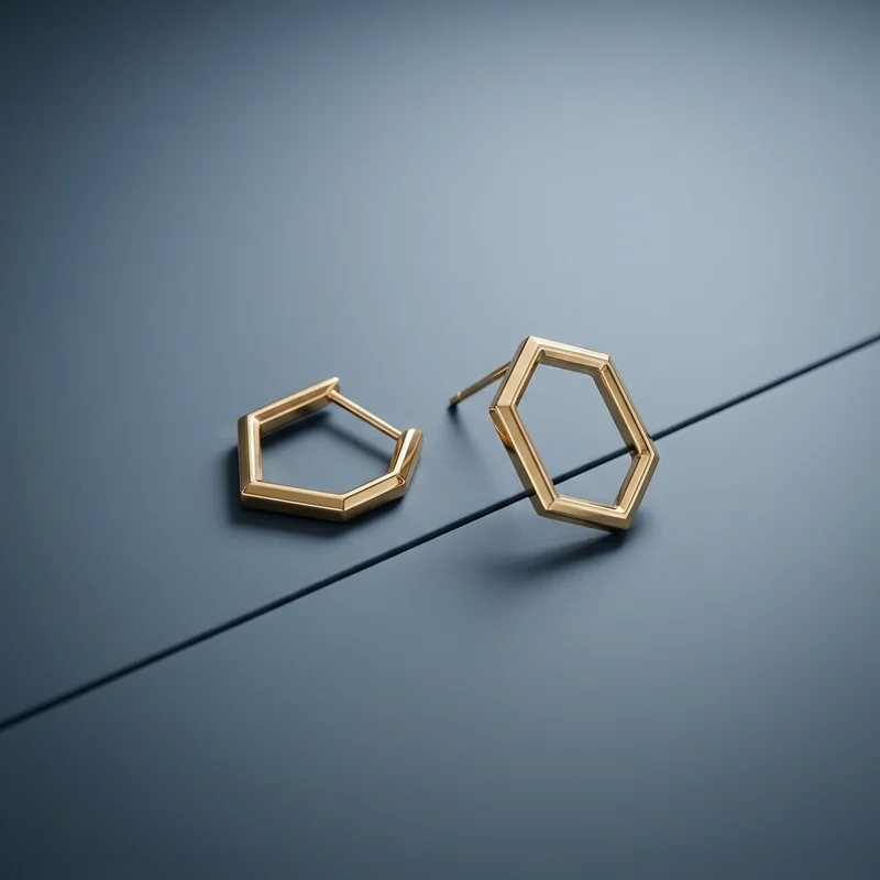 Geometric gold earrings on blue