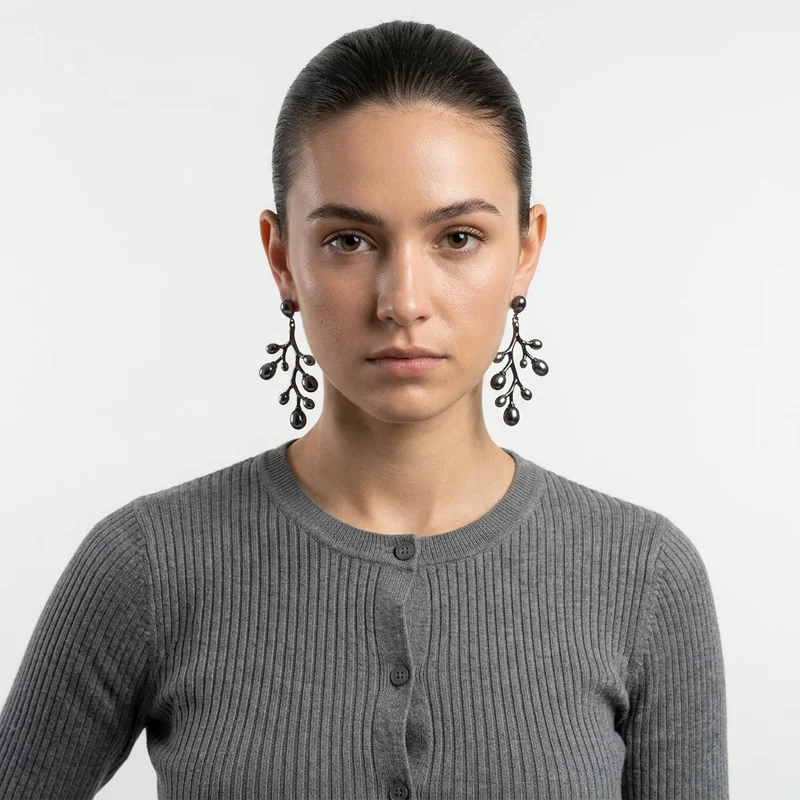 Model in black branch earrings