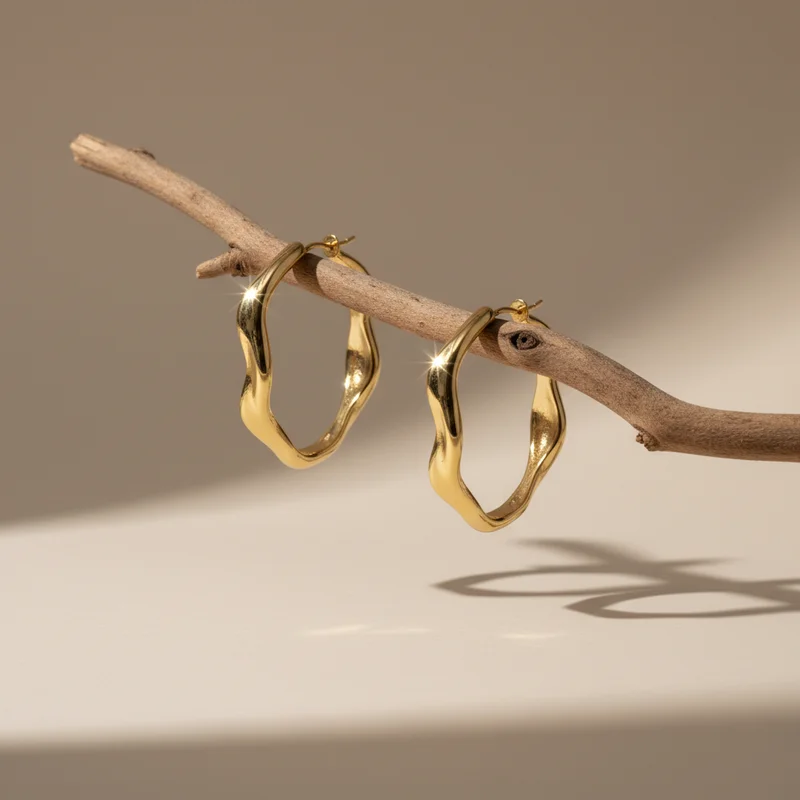 Gold wavy hoops on a branch