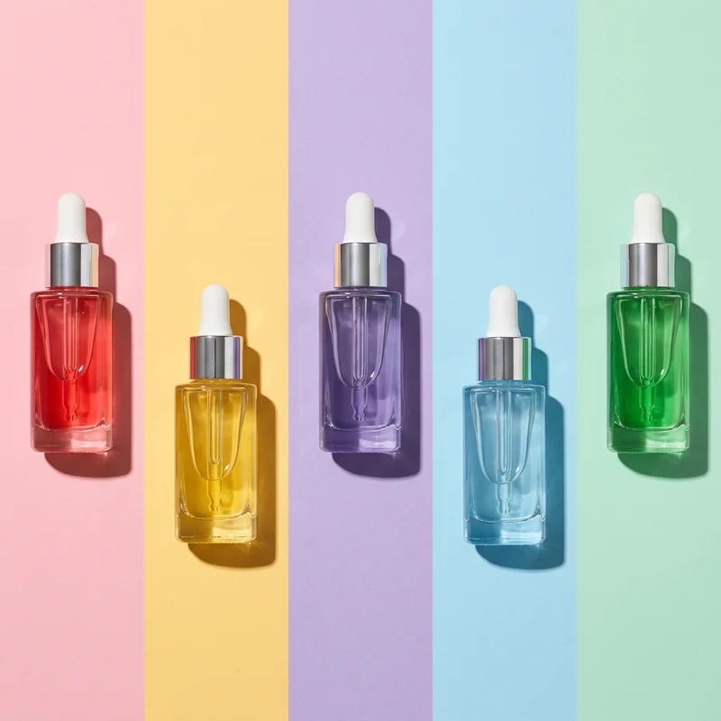 Pastel serum bottles on paper