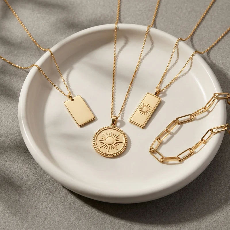 Gold necklaces on ceramic dish