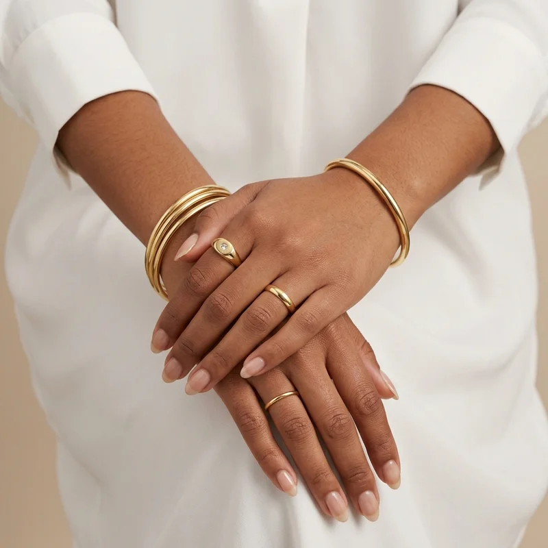 Elegant gold jewelry on hands