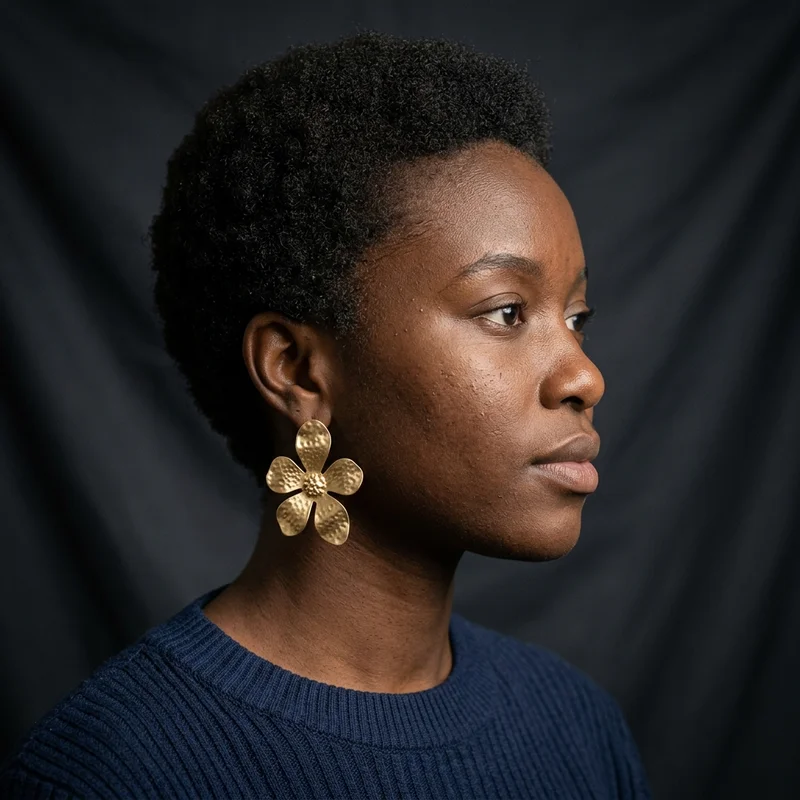Gold flower earring on model
