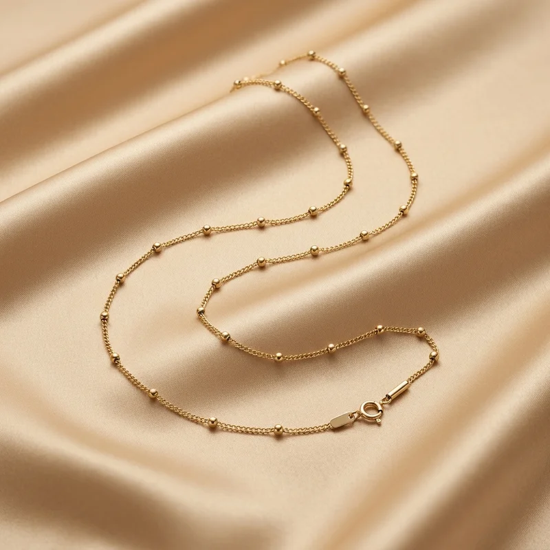 Gold beaded chain on satin