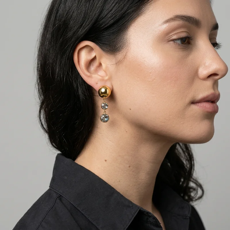 Elegant gold ball earring close-up