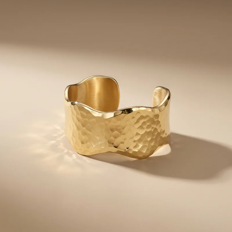 Hammered gold cuff on beige