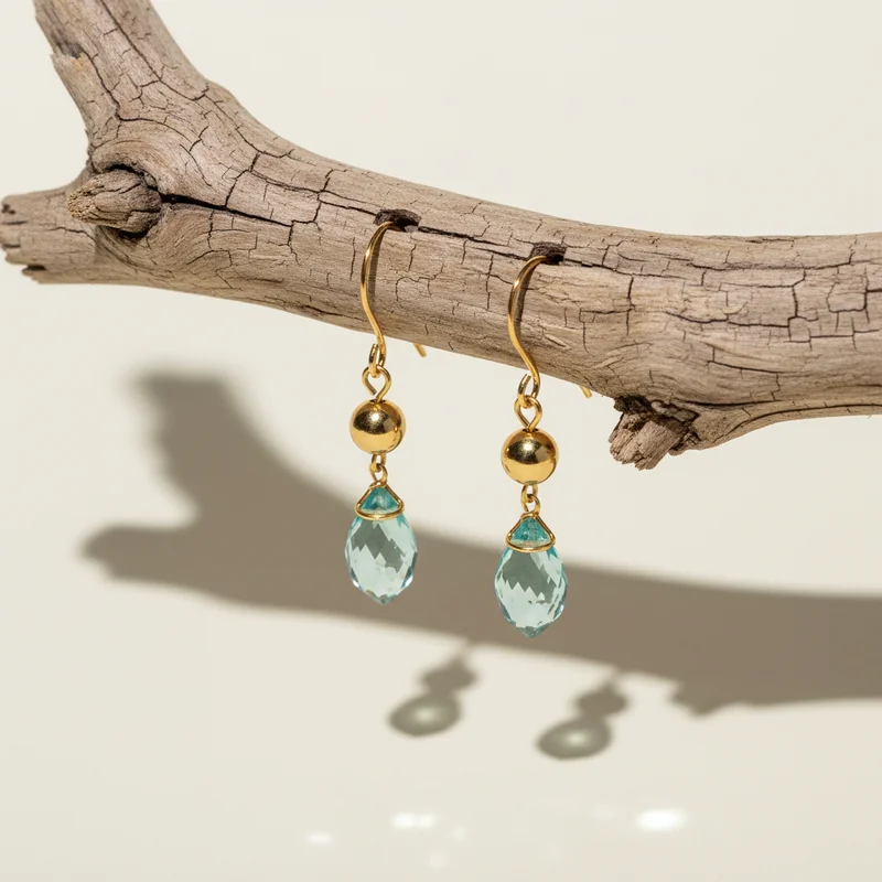 Natural gemstone earrings on wood
