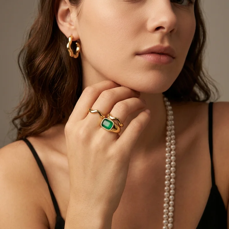 Elegant gold and green jewelry on model