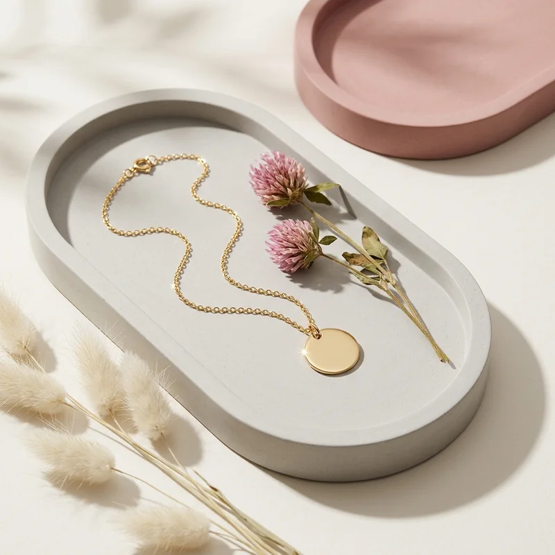 Gold necklace on concrete tray