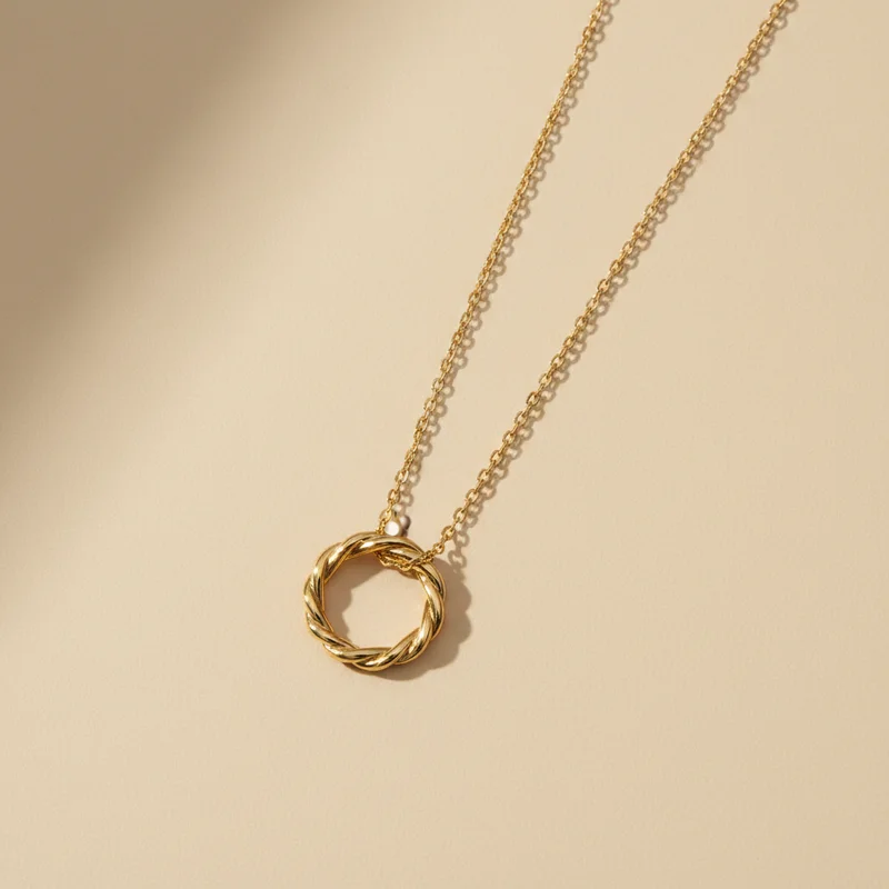 Minimalist gold necklace on beige