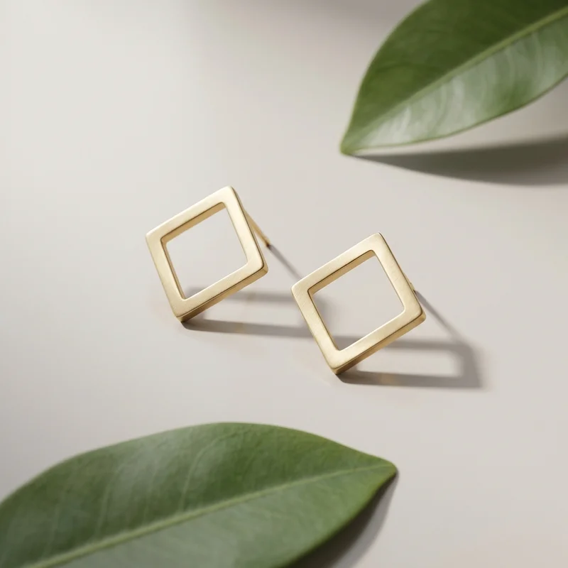 Minimalist gold earrings on white