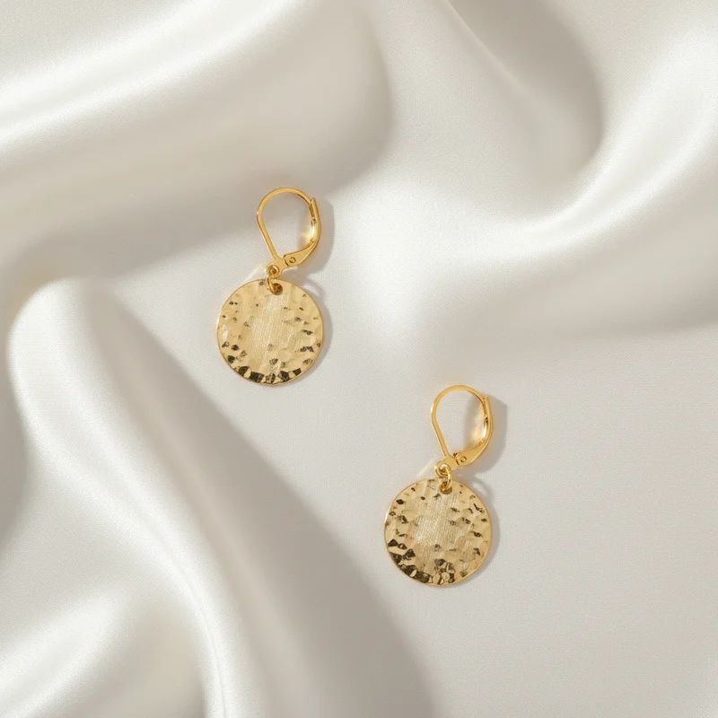 Elegant gold earrings on silk