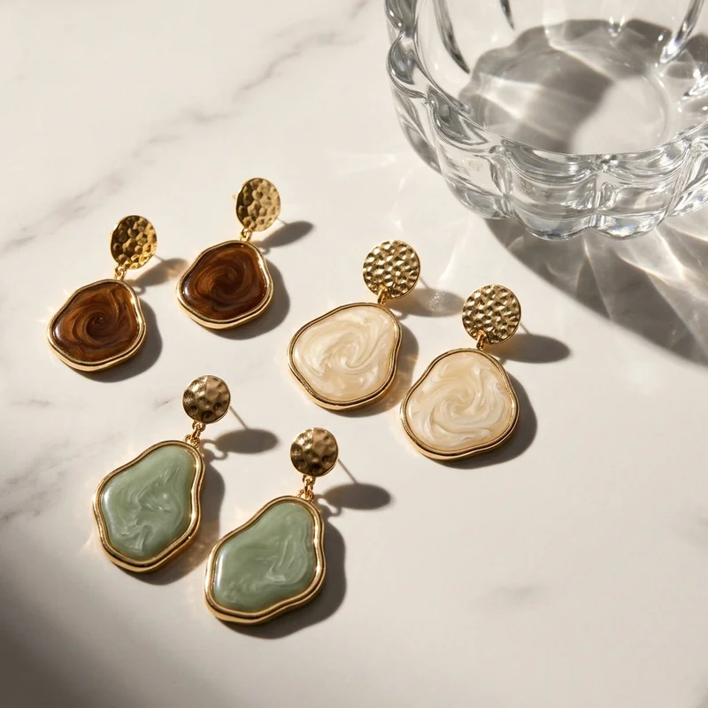 Sunlit resin earrings on marble