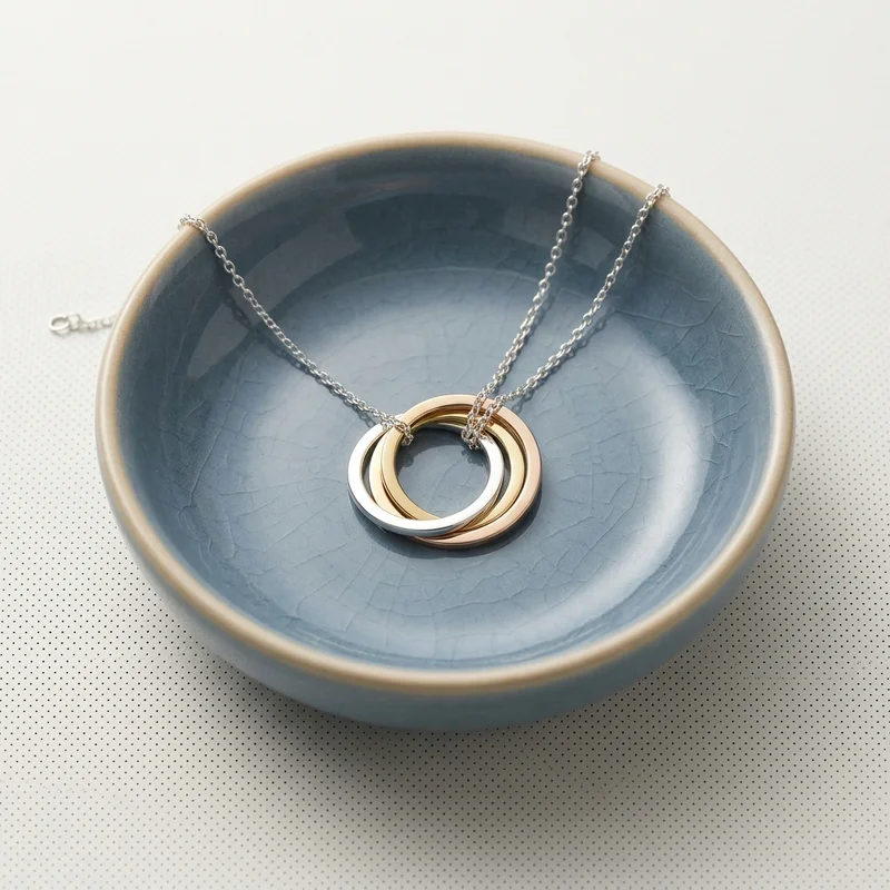 Minimalist jewelry in ceramic dish