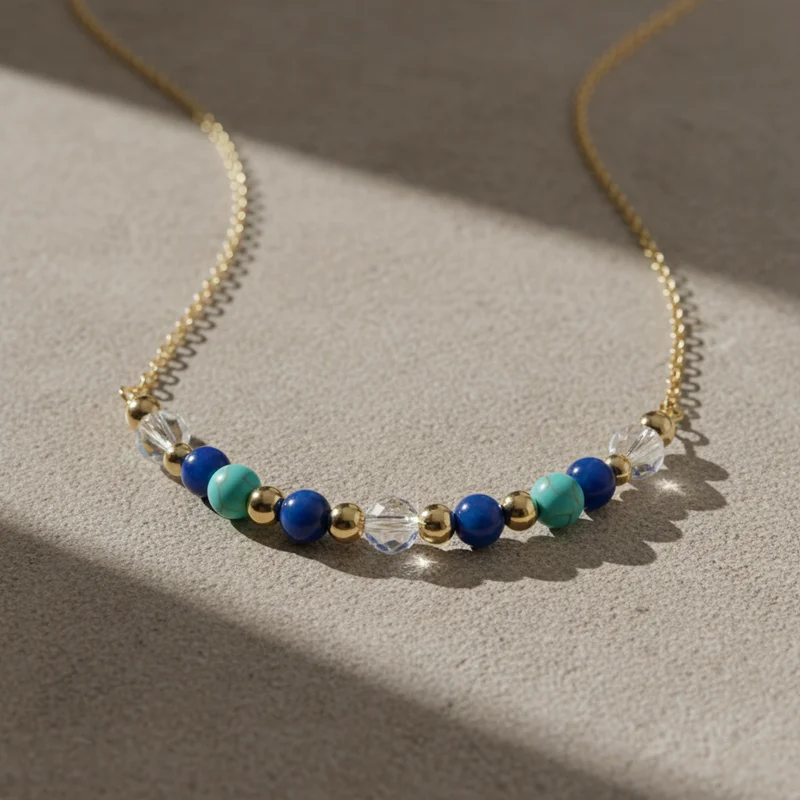 Beaded gold necklace on stone