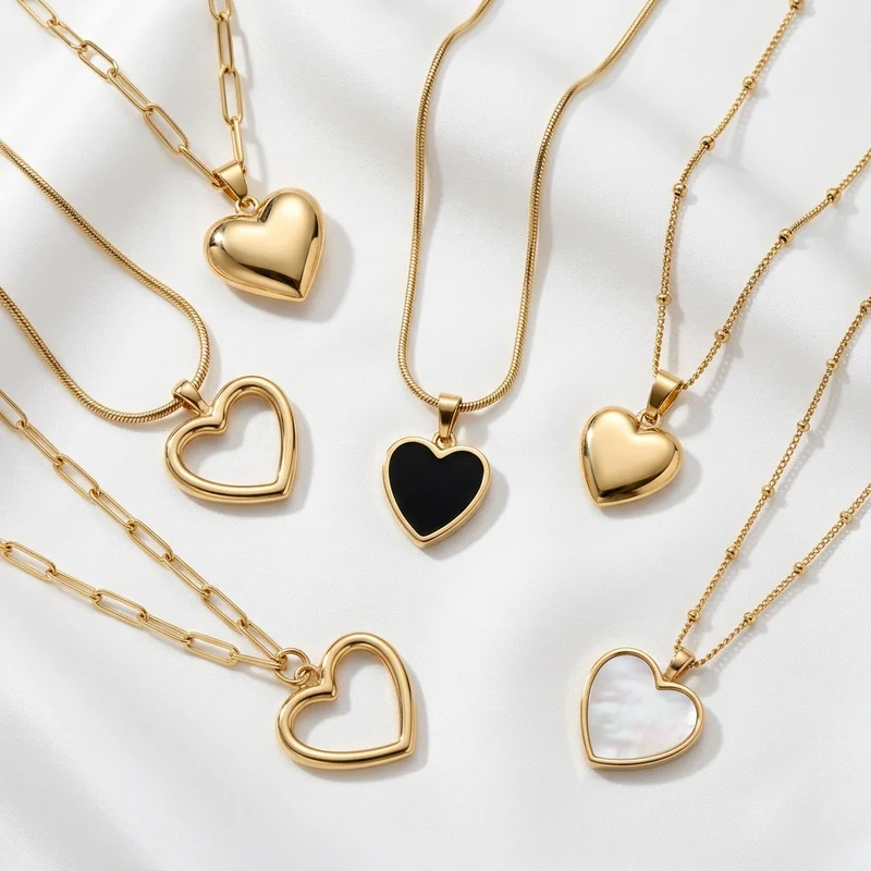 Elegant gold heart necklaces on silk