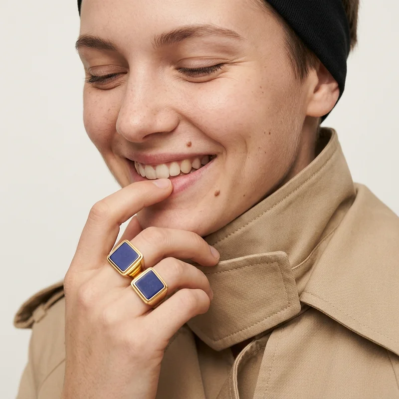 Smiling woman in trench coat with rings